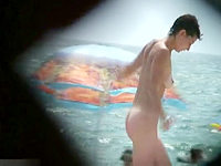 The hidden spy camera is working and recording the naked babe on the nudist beach!