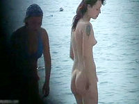 Hot nudism video with tattooed bimbo resting at the beach without any cloths.